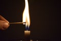 Match Stick Catching Fire from Burning Candle Royalty Free Stock Photo