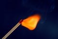 Match stick ignited burning bright big fire flame with blue smoke Royalty Free Stock Photo