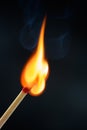 Match stick  ignited burning bright big fire flame with smoke on black Royalty Free Stock Photo