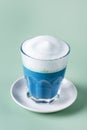 Matcha Blue tea latte in t glass on Green background Healthy Drink Vertical