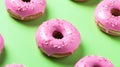 Matcha donuts. Pink matcha donuts on green background. Homemade matcha doughnuts covered with pink matcha powder graze, matcha