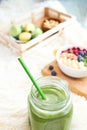 Matcha green tea, breakfast top view white background. oatmeal with berries, toasts on a wooden tray, nuts, coffee Royalty Free Stock Photo