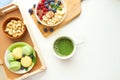 Matcha green tea, breakfast top view white background. oatmeal with berries, toasts on a wooden tray, nuts, coffee Royalty Free Stock Photo