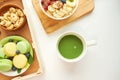 Matcha green tea, breakfast top view white background. oatmeal with berries, toasts on a wooden tray, nuts, coffee Royalty Free Stock Photo