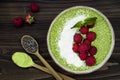 Matcha green tea chia seed pudding bowl, vegan dessert with raspberry and coconut milk. Overhead, top view, flat lay. Royalty Free Stock Photo