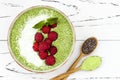 Matcha green tea chia seed pudding bowl, vegan dessert with raspberry and coconut milk. Overhead, top view, flat lay. Royalty Free Stock Photo