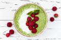 Matcha green tea chia seed pudding bowl, vegan dessert with raspberry and coconut milk. Overhead, top view, flat lay. Royalty Free Stock Photo