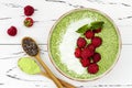 Matcha green tea chia seed pudding bowl, vegan dessert with raspberry and coconut milk. Overhead, top view, flat lay. Royalty Free Stock Photo