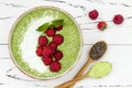 Matcha green tea chia seed pudding bowl, vegan dessert with raspberry and coconut milk. Overhead, top view, flat lay. Royalty Free Stock Photo