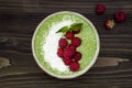 Matcha green tea chia seed pudding bowl, vegan dessert with raspberry and coconut milk. Overhead, top view, flat lay. Royalty Free Stock Photo