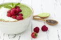 Matcha green tea chia seed pudding bowl, vegan dessert with raspberry and coconut milk. Overhead, top view, flat lay.