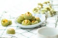 Matcha Green Tea Cookies Singapore or Matcha Green Tea cashew Cookies with a cup of hot tea blurred on green vintage background Royalty Free Stock Photo