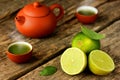 Matcha green tea, fresh limes, tea leaves on an old rustic wooden table Royalty Free Stock Photo