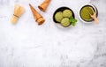 Matcha green tea ice cream with waffle cone and mint leaves setup on white stone background . Summer and Sweet menu concept