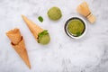 Matcha green tea ice cream with waffle cone and mint leaves  setup on white stone background . Summer and Sweet menu concept Royalty Free Stock Photo