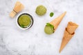 Matcha green tea ice cream with waffle cone and mint leaves  setup on white stone background . Summer and Sweet menu concept Royalty Free Stock Photo
