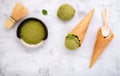 Matcha green tea ice cream with waffle cone and mint leaves  setup on white stone background . Summer and Sweet menu concept Royalty Free Stock Photo
