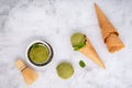 Matcha green tea ice cream with waffle cone and mint leaves setup on white stone background . Summer and Sweet menu concept Royalty Free Stock Photo