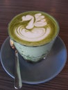 Matcha green tea latte with beauitiful latte art and served in a glass