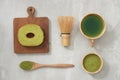 Matcha green tea latte in a cup and tea ceremony utensils with German cake. Copy space Royalty Free Stock Photo
