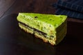 Matcha Green Tea Layer Cake Slice on Dark Wooden Board Royalty Free Stock Photo