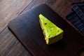 Matcha Green Tea Layer Cake Slice on Dark Wooden Board Royalty Free Stock Photo