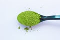 A spoon with powdered matcha green tea, isolated on light background, copy space, top view Royalty Free Stock Photo