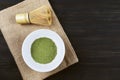Matcha, green tea powder with bamboo whisk on wooden background Royalty Free Stock Photo