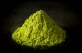 Matcha green tea powder on black cast iron background Royalty Free Stock Photo