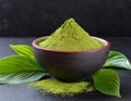 Matcha green tea powder in bowl, black table, green matcha leaves Royalty Free Stock Photo