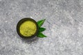 Matcha green tea powder close up on green background