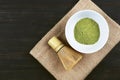 Matcha, green tea powder with bamboo whisk on wooden background Royalty Free Stock Photo