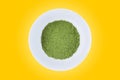 Matcha, green tea powder isolated on yellow background