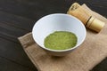 Matcha, green tea powder with bamboo whisk on wooden background Royalty Free Stock Photo