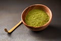 Close up powder of matcha tea is partially dissolved in hot water