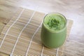 Matcha Green Tea Smoothie in glass on bamboo mat on table Royalty Free Stock Photo