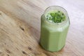 Matcha Green Tea Smoothie in glass jar on table Royalty Free Stock Photo