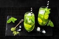 Matcha iced green tea with lime and fresh mint on black stone slate background. Super food drink. Royalty Free Stock Photo