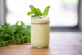 matcha latte in a rustic mason jar, garnished with mint leaf