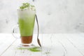 Matcha latte with salted caramel in tall glass. Royalty Free Stock Photo