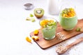 Matcha overnight oatmeal and fruits in glass, rich in protein breakfast or snack