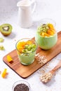 Matcha overnight oatmeal and fruits in glass, rich in protein breakfast or snack