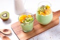 Matcha overnight oatmeal and fruits in glass, rich in protein breakfast or snack