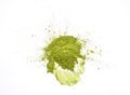 Matcha powder explosion on white background top view. Matcha is made of finely ground green tea powder. It`s very common in