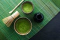 Matcha powder. Organic green matcha tea ceremony. Healthy drink. Traditional japanese drink on black wooden background Royalty Free Stock Photo