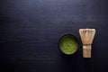 Matcha powder. Organic green matcha tea ceremony. Healthy drink. Traditional japanese drink on black wooden background Royalty Free Stock Photo