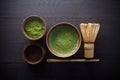 Matcha powder. Organic green matcha tea ceremony. Healthy drink. Traditional japanese drink on black wooden background Royalty Free Stock Photo