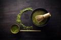 Matcha powder. Organic green matcha tea ceremony. Healthy drink. Traditional japanese drink on black wooden background Royalty Free Stock Photo