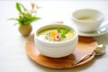 matcha pudding in white cup, tea leaves scattering Royalty Free Stock Photo