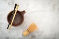 Matcha set bamboo matcha whisk and chashaku tea scoop,matcha ceramic bowl set up on white concrete background.